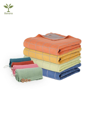 Stack of folded banana double cloth with a white background.