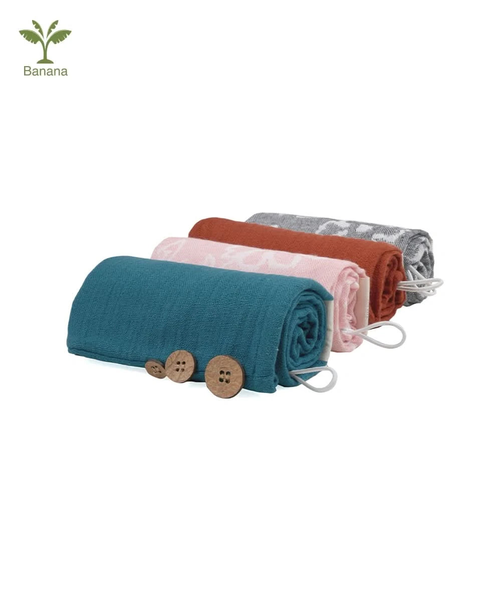 Set of rolled-up towels in teal, coral , and terracotta , charcoal grey with buttons on a white background