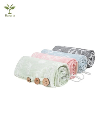 Set of folded Banana Jacquard floral hair towels in pastel colors with wooden buttons on a white background.