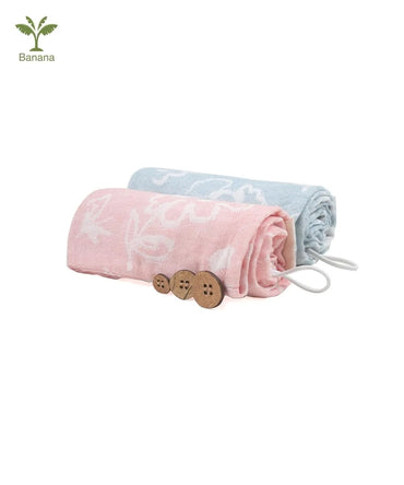 Two folded Banana hair towels, one coral and chalk blue , with buttons on a white background.
