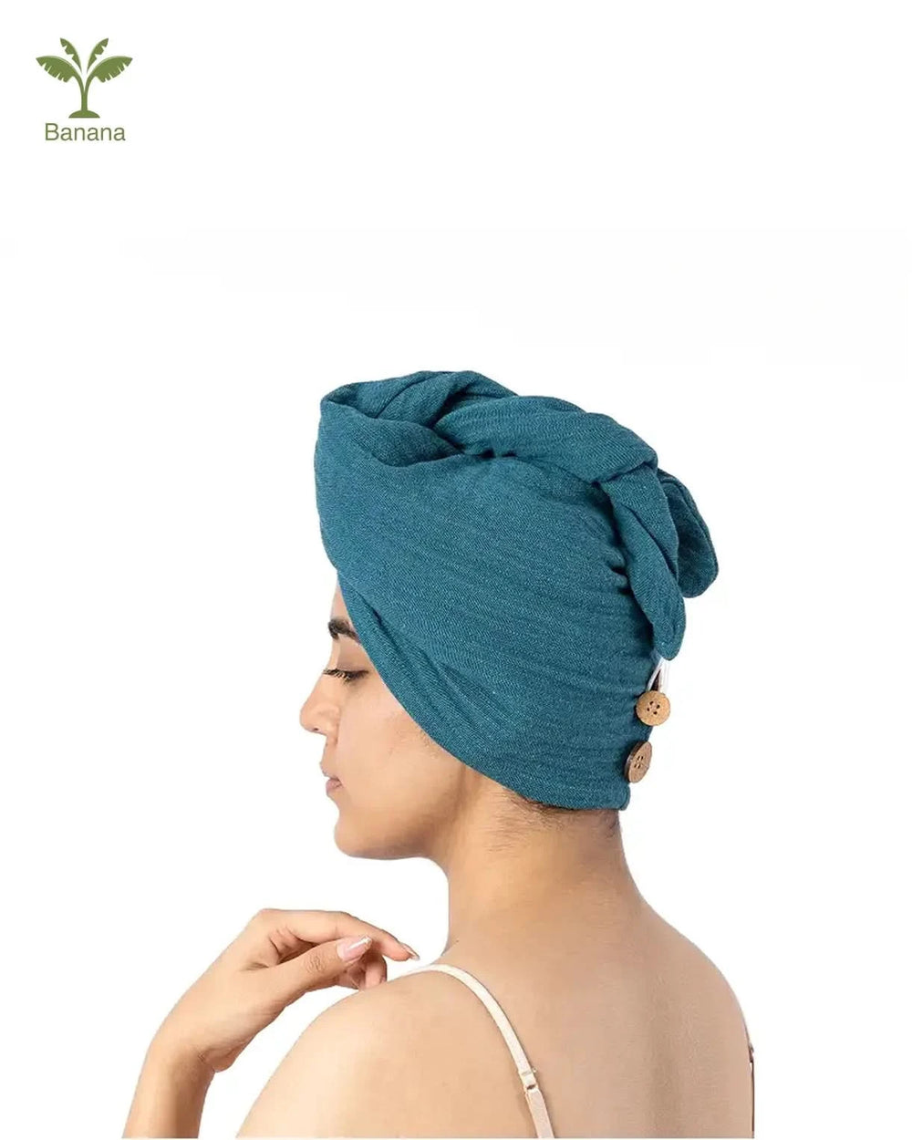 Woman wearing a teal bamboo towel on her head with a white background