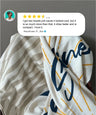Two towels with different patterns and a customer review overlay on a gray background